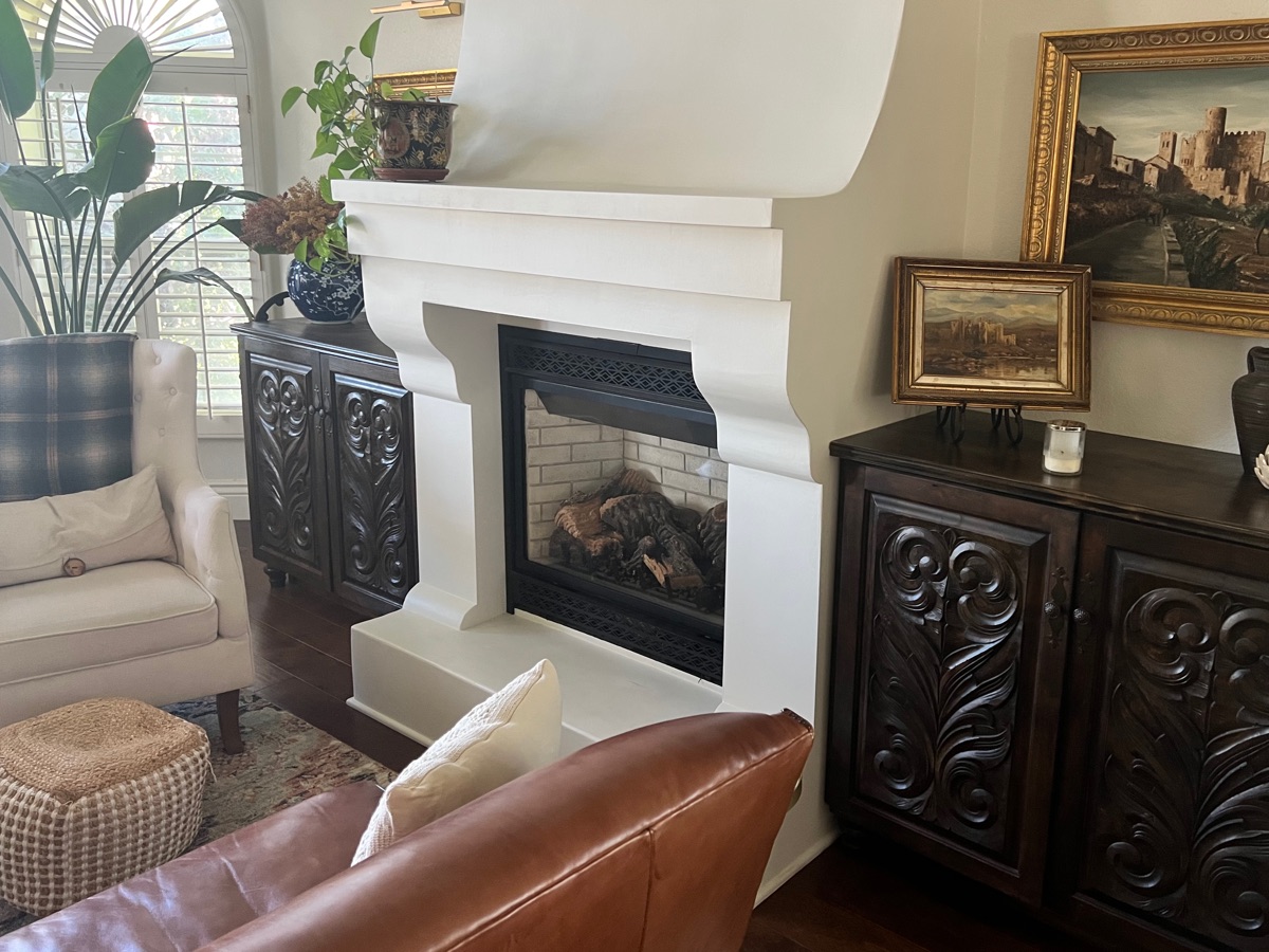 Custom brick fireplace with dark wood mantel