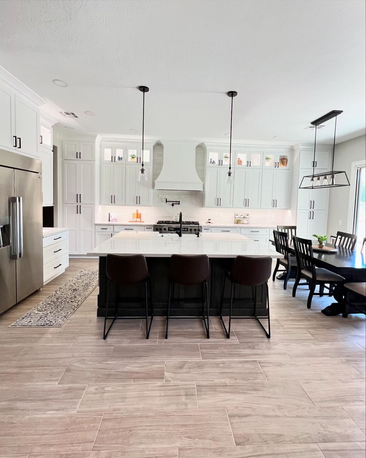 Kitchen remodel with cherry cabinets, marble waterfall island countertops